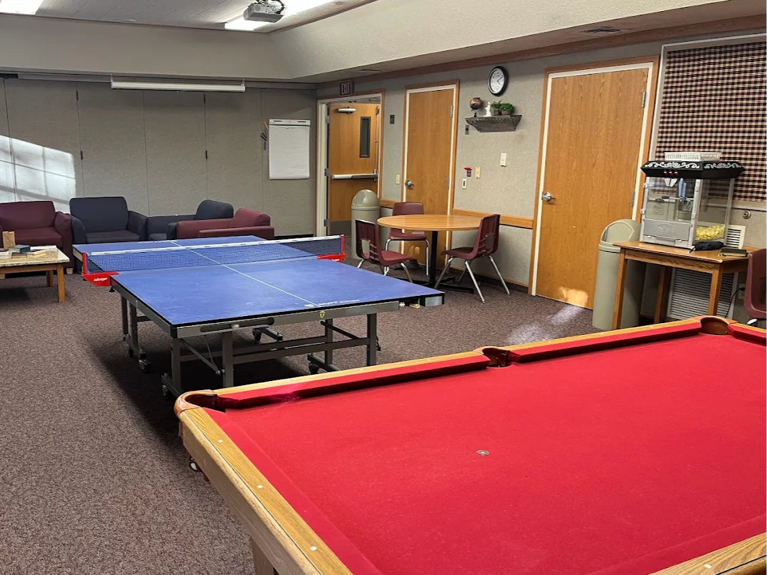 Game room with pool table, ping pong table, and foosball table.